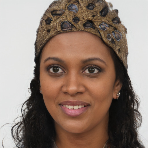 Joyful black young-adult female with long  brown hair and brown eyes