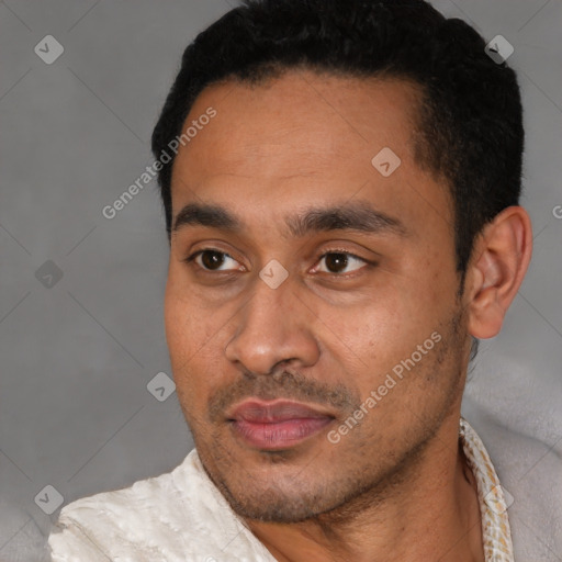 Joyful latino young-adult male with short  black hair and brown eyes