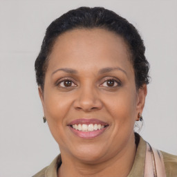 Joyful latino adult female with short  brown hair and brown eyes