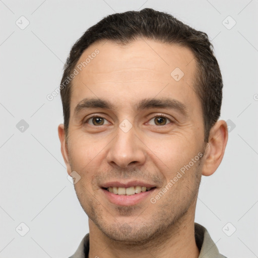 Joyful white young-adult male with short  brown hair and brown eyes