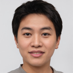 Joyful asian young-adult male with short  brown hair and brown eyes