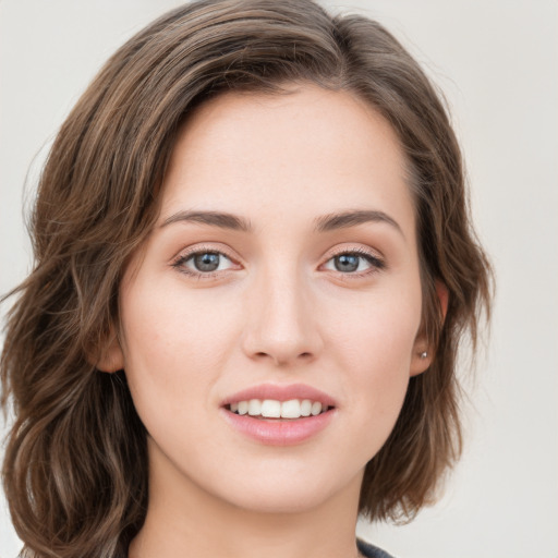 Joyful white young-adult female with long  brown hair and green eyes