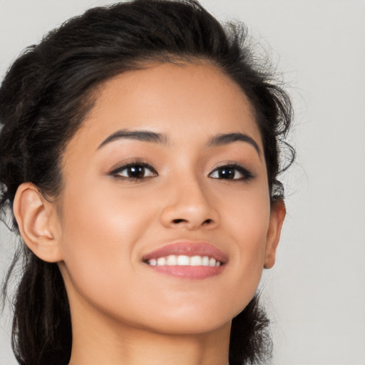 Joyful latino young-adult female with long  brown hair and brown eyes