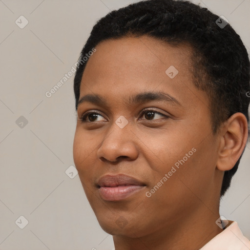 Joyful black young-adult male with short  black hair and brown eyes