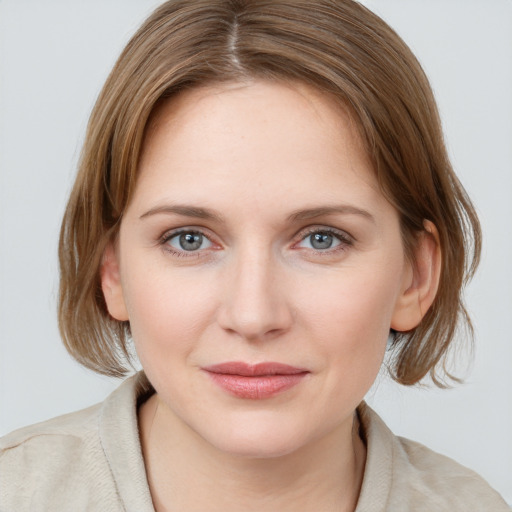 Joyful white young-adult female with medium  brown hair and blue eyes