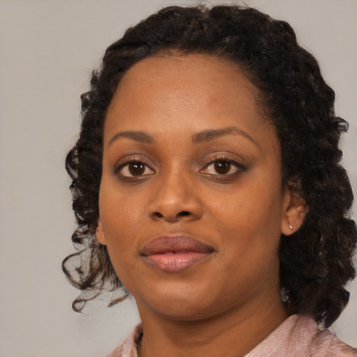 Joyful black young-adult female with medium  black hair and brown eyes