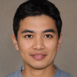 Joyful asian young-adult male with short  black hair and brown eyes