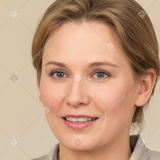 Joyful white adult female with medium  brown hair and grey eyes