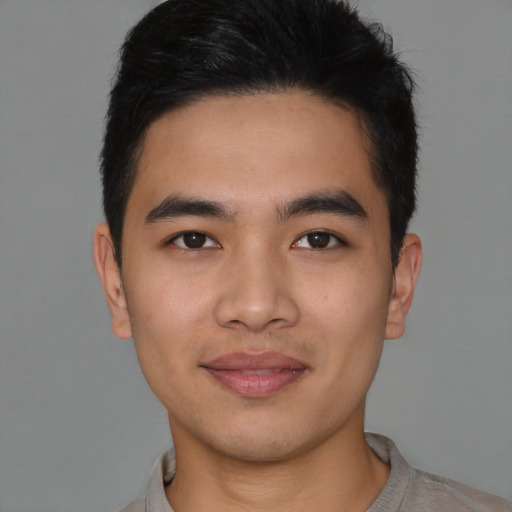 Joyful latino young-adult male with short  brown hair and brown eyes