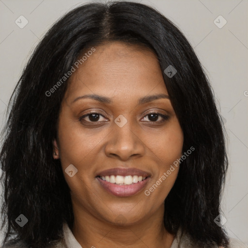 Joyful black young-adult female with long  black hair and brown eyes