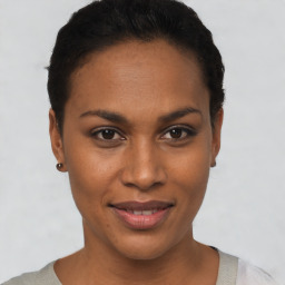 Joyful black young-adult female with short  brown hair and brown eyes