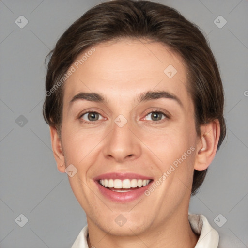 Joyful white young-adult female with short  brown hair and grey eyes