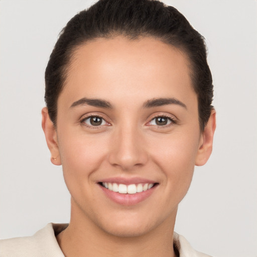 Joyful white young-adult female with short  brown hair and brown eyes