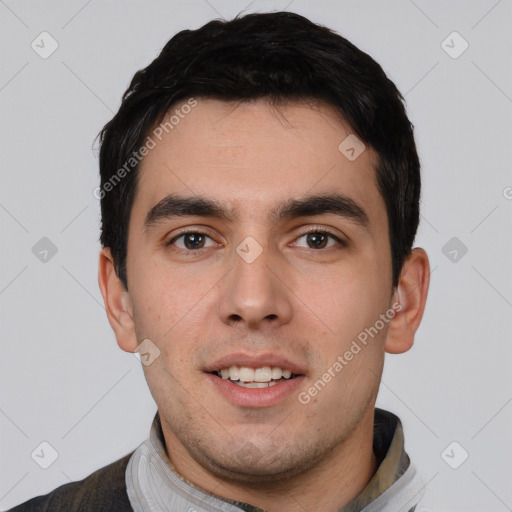 Joyful white young-adult male with short  black hair and brown eyes