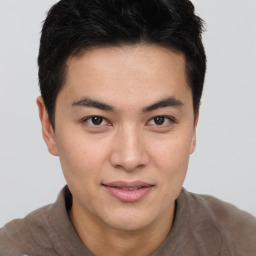 Joyful asian young-adult male with short  brown hair and brown eyes