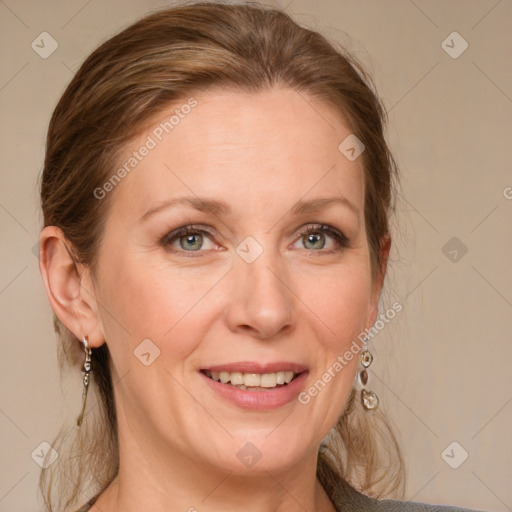 Joyful white adult female with medium  brown hair and blue eyes