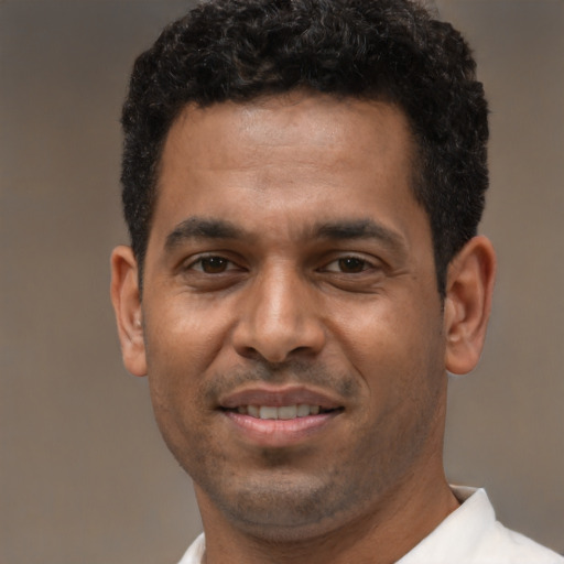 Joyful latino adult male with short  black hair and brown eyes