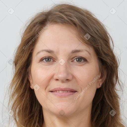 Joyful white adult female with long  brown hair and brown eyes