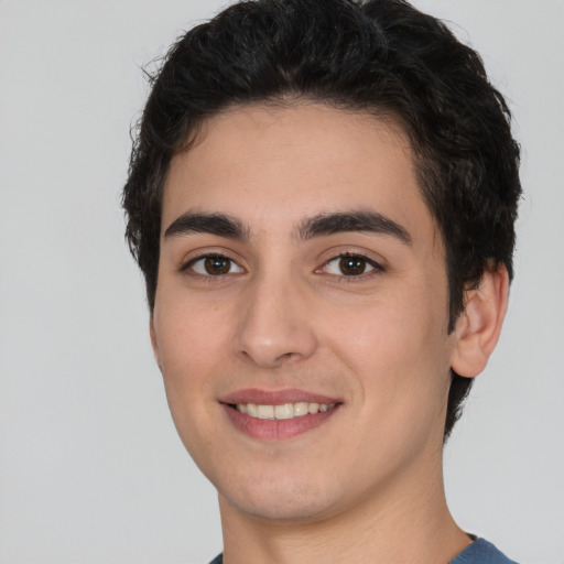 Joyful white young-adult male with short  black hair and brown eyes