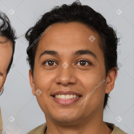 Joyful latino young-adult male with short  brown hair and brown eyes