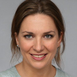 Joyful white young-adult female with medium  brown hair and blue eyes