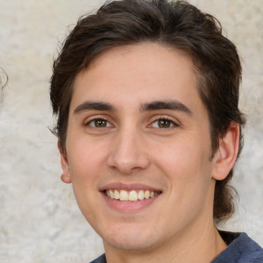 Joyful white young-adult male with medium  brown hair and brown eyes