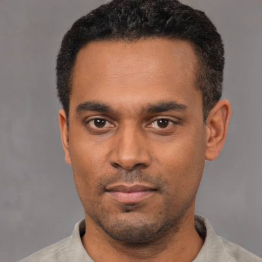 Neutral black young-adult male with short  black hair and brown eyes