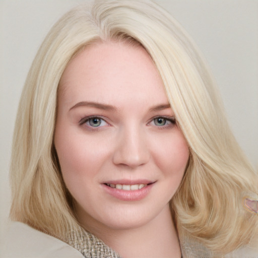 Joyful white young-adult female with long  brown hair and blue eyes