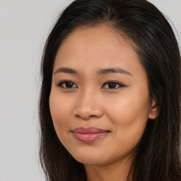 Joyful asian young-adult female with long  brown hair and brown eyes