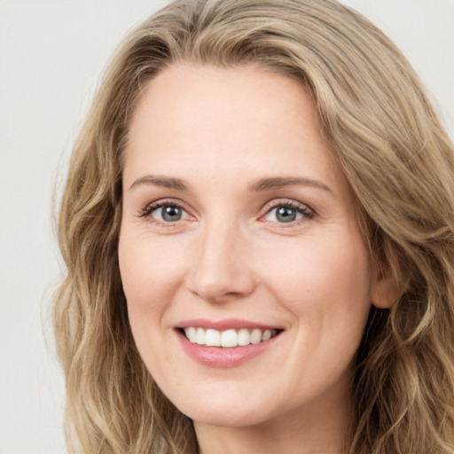 Joyful white young-adult female with long  brown hair and green eyes