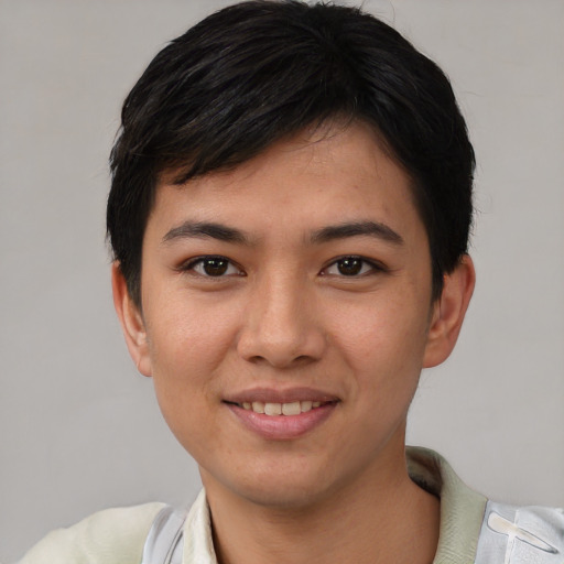 Joyful asian young-adult male with short  black hair and brown eyes