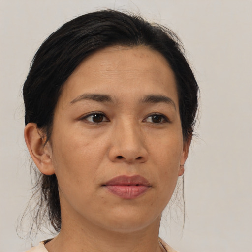 Joyful asian adult female with medium  brown hair and brown eyes