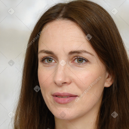 Joyful white adult female with long  brown hair and grey eyes