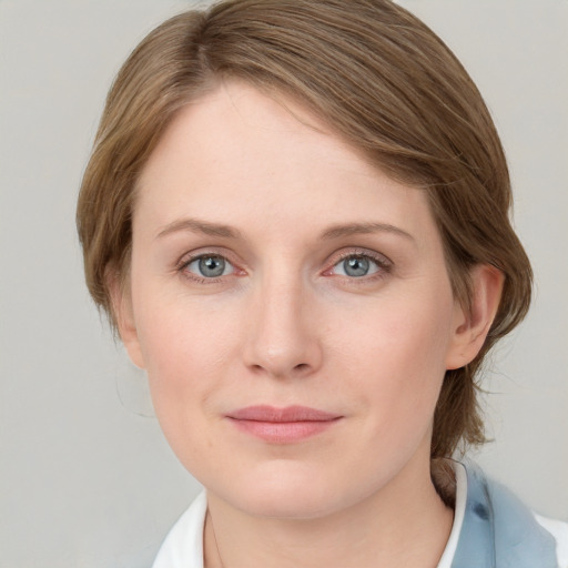 Joyful white young-adult female with medium  brown hair and blue eyes