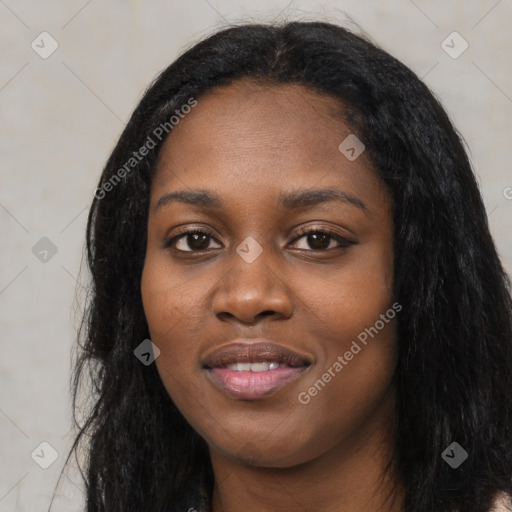 Joyful black young-adult female with long  black hair and brown eyes