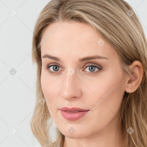 Joyful white young-adult female with long  brown hair and blue eyes