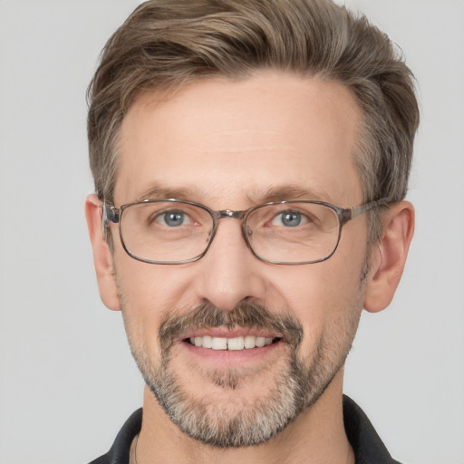 Joyful white adult male with short  brown hair and grey eyes