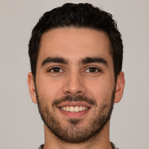 Joyful white young-adult male with short  brown hair and brown eyes