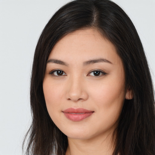 Joyful asian young-adult female with long  brown hair and brown eyes