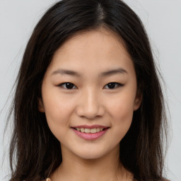 Joyful asian young-adult female with long  brown hair and brown eyes