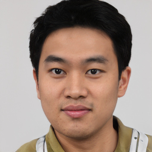 Joyful asian young-adult male with short  black hair and brown eyes