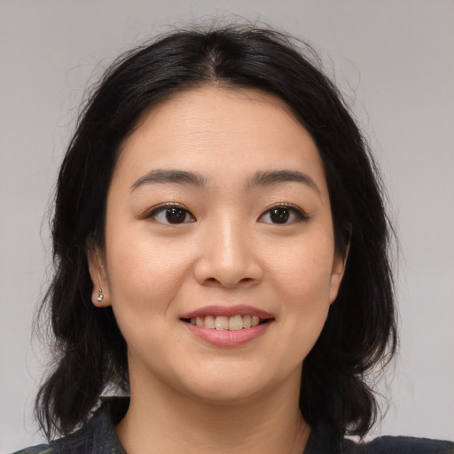Joyful asian young-adult female with medium  brown hair and brown eyes
