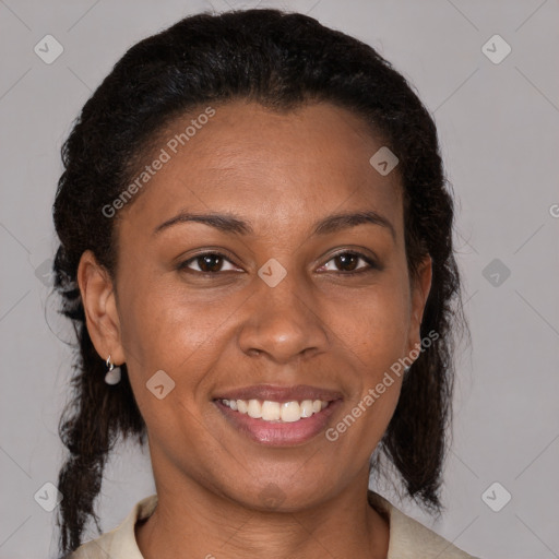 Joyful black adult female with medium  brown hair and brown eyes