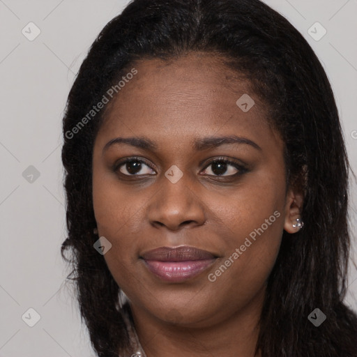 Joyful black young-adult female with long  brown hair and brown eyes