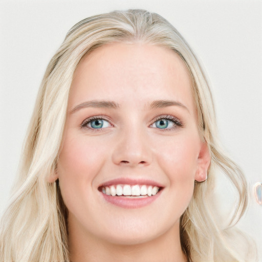 Joyful white young-adult female with long  blond hair and blue eyes