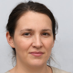 Joyful white adult female with medium  brown hair and brown eyes