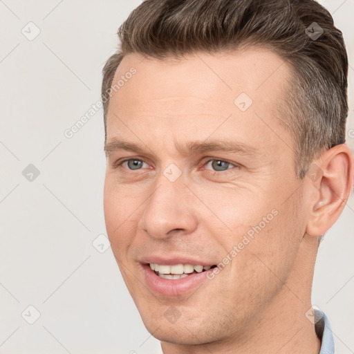 Joyful white adult male with short  brown hair and grey eyes