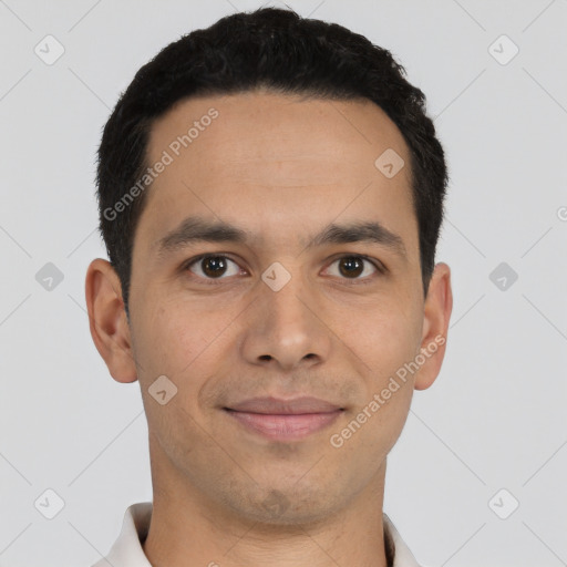 Joyful latino young-adult male with short  black hair and brown eyes