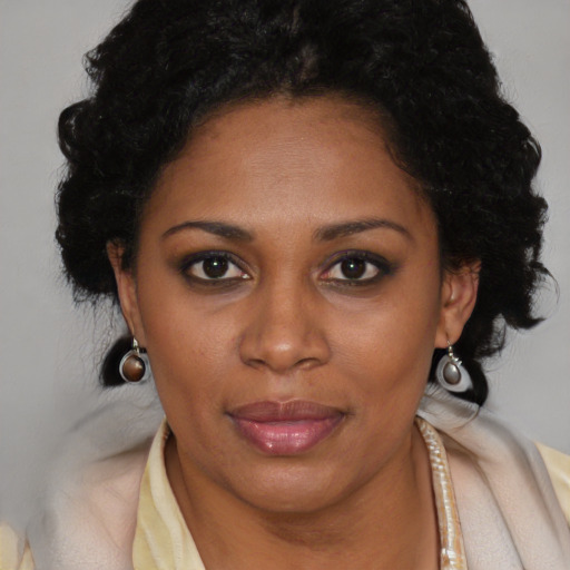 Joyful black young-adult female with medium  brown hair and brown eyes