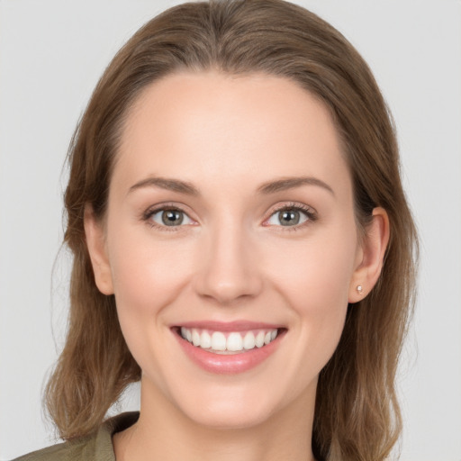 Joyful white young-adult female with long  brown hair and grey eyes